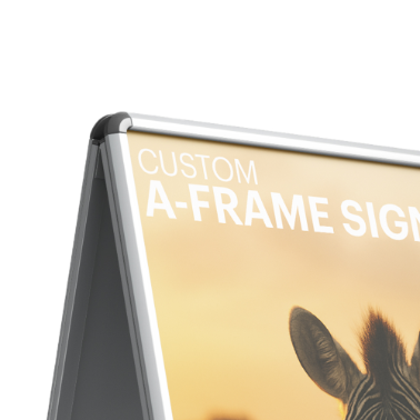 Close-up view of the top corner of an A-frame sign showing the text 