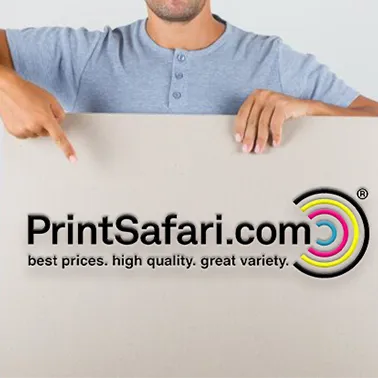 Person holding a large rectangular sticker with the PrintSafari.com logo, partially rolled out on a flat surface.