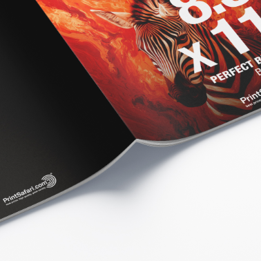 Close-up view of the booklet's spiral binding and cover with a lion illustration, displayed diagonally on a white surface.