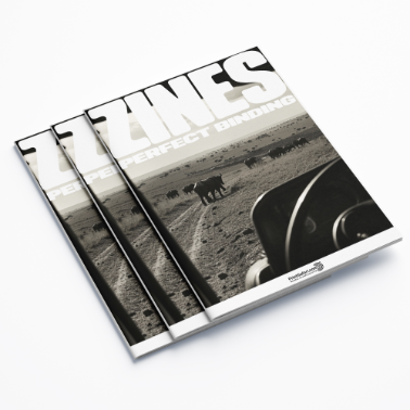 Stack of zines with a black-and-white cover photo of elephants walking in the wild, labeled