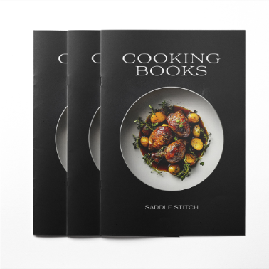 Three saddle-stitched cooking books with a minimalist black cover featuring a plate of roasted meat and vegetables, titled 