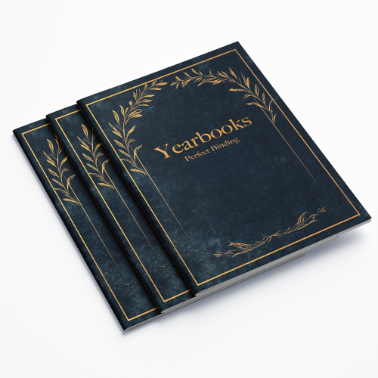 Stack of yearbooks with a vintage navy-blue and gold ornate cover design, titled 