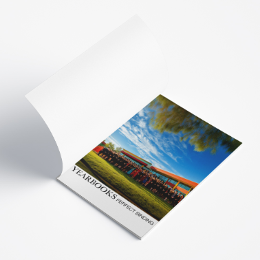 Open yearbook showing an interior spread with a large landscape photo and caption text, laid flat on a white surface.